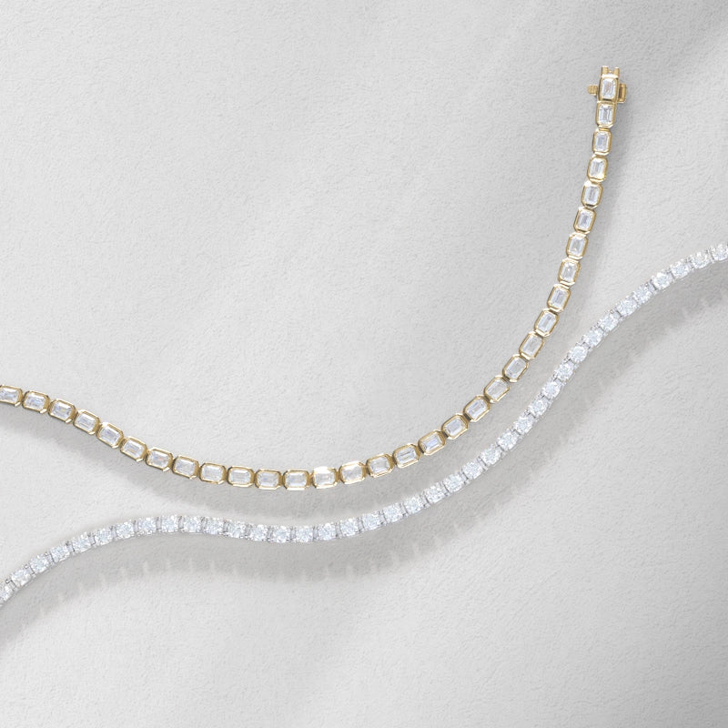 top view of round and emerald cut diamond tennis bracelets in yellow and white gold
