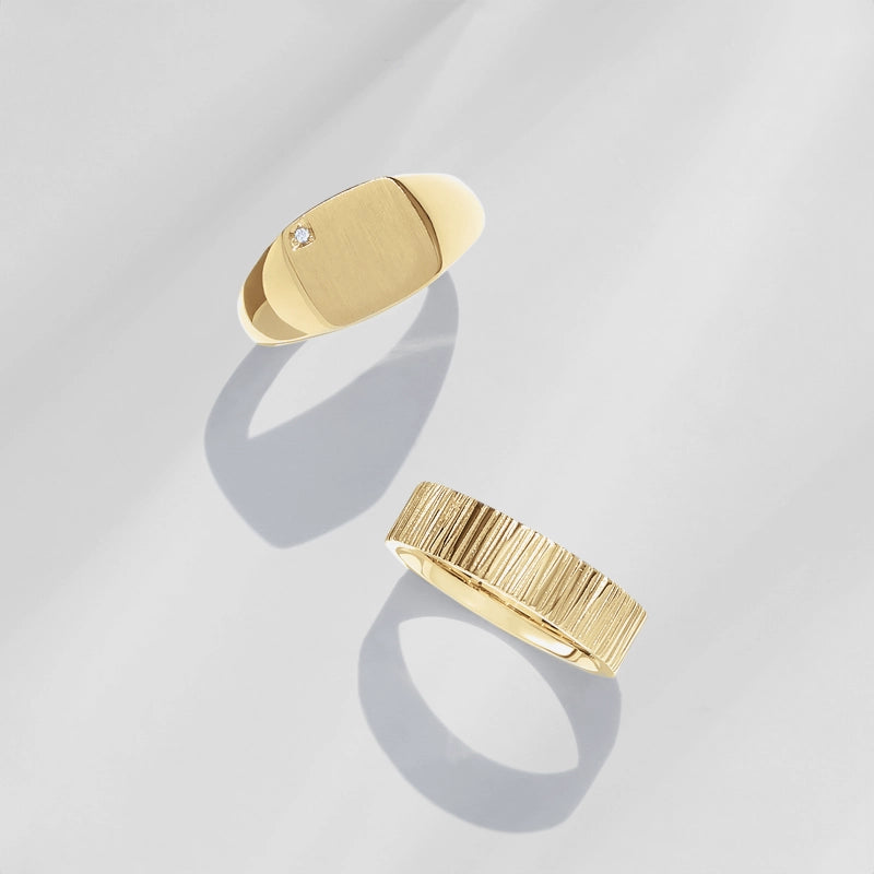 top view of two mens yellow gold rings